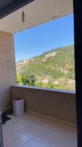 a room with a window with a view of a mountain at شقة مفروشة in Ajloun