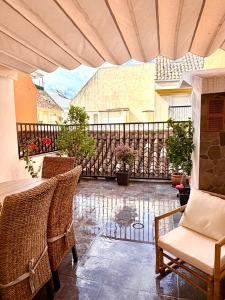 an outdoor patio with chairs and a fence at Casa Natali in Fuengirola