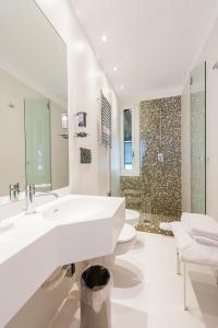 a white bathroom with two sinks and a shower at LHP Suite Santa Margherita in Santa Margherita Ligure