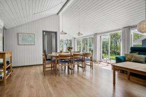a living room with a table and chairs and a couch at 30717-Odder-Alrovej-153 in Amstrup