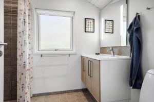a bathroom with a shower and a sink and a window at 30717-Odder-Alrovej-153 in Amstrup +16 photos