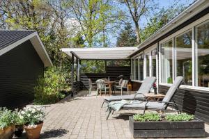 a patio with chairs and a table on a house at 30717-Odder-Alrovej-153 in Amstrup