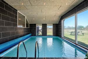 a swimming pool in a house with a large window at JB500-Brovst-Kronvildtvej-31 in Tranum Strand