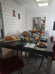 a table with plates of food on it at Ô Sens Jacuzzi et Massages in Challans