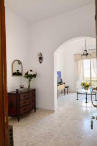 a living room with a wooden dresser and a table at Seaview luxury flat 4 bedrooms in Sliema