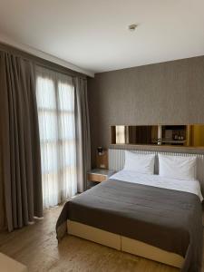 a bedroom with a large bed and large windows at The Alaçatı Ariel Hotel in Çeşme +47 photos