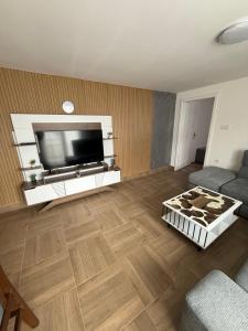 a living room with a large flat screen tv at Deskom Stan na dan in Despotovac
