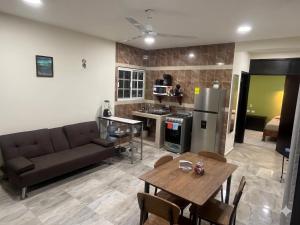 a living room with a couch and a table at Casa Caribe in Bacalar