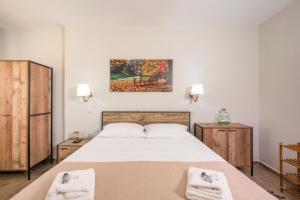 a bedroom with a bed with two towels at Archontiko Haris in Kolymvari