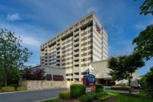 a tall white building with a red telephone booth in front at Fairfield Inn & Suites by Marriott Charlotte Uptown in Charlotte