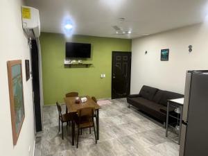 a living room with a couch and a table at Casa Caribe in Bacalar