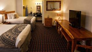 a hotel room with two beds and a flat screen tv at PIER BLUE INN Old Saybrook - Essex in Old Saybrook +23 photos