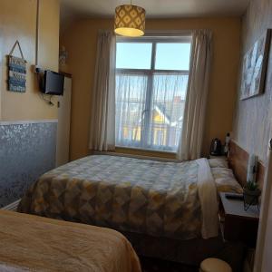 a hotel room with a bed and a window at THE ROCK n ROLL in Blackpool