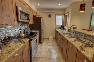 a kitchen with a sink and a stove top oven at Ski Run 201 by SummitCove Lodging in Colorado in Keystone