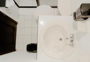 a bathroom with a white sink and a toilet at Hotel La Antigua Express in San Cristóbal de Las Casas +28 photos