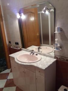 baño con 2 lavabos y espejo grande en Casa Rural Amelia, en Cepeda