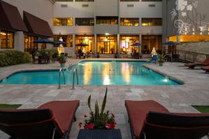 a swimming pool with chairs and a building at Fairfield Inn & Suites by Marriott Charlotte Uptown in Charlotte