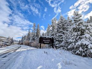 a sign on the side of a snow covered road at Ski Run 302 by SummitCove Lodging in Colorado in Keystone
