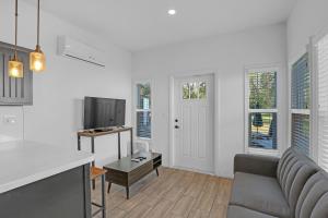 a living room with a couch and a tv at Tiny Blue at Yosemite Gateway in Groveland