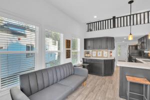 a living room with a couch and a kitchen at Tiny Blue at Yosemite Gateway in Groveland
