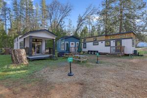 a couple of tiny homes parked in a field at Tiny Blue at Yosemite Gateway in Groveland