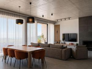 a living room with a table and a couch at Luxury Villa #1 in Tabakhmela +21 photos