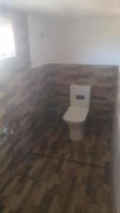 a bathroom with a toilet in a room at Himidiri Villa in Nuwara Eliya