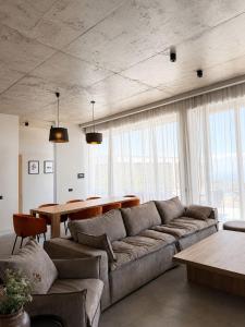 a living room with a couch and a table at Luxury Villa #1 in Tabakhmela