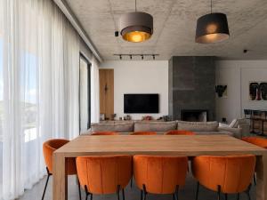 a dining room with a table and orange chairs at Luxury Villa #1 in Tabakhmela