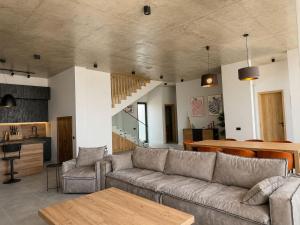 a living room with a couch and a table at Luxury Villa #1 in Tabakhmela