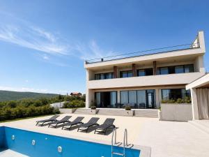 a house with a swimming pool in front of it at Luxury Villa #1 in Tabakhmela