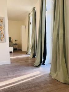 a row of curtains in a room with wooden floors at Schonekind Appartement Soest in Soest