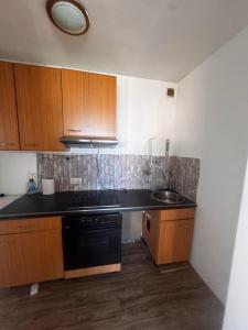 a kitchen with a black stove and a sink at Freilassing Unterkünfte in Freilassing