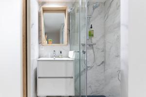 a bathroom with a sink and a shower at Les Petits Volets 2 à 100m de la mer in Antibes