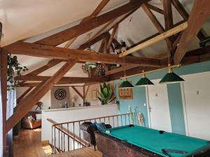 a room with a pool table in a room at Le Reflet de la Semoy in Les Hautes-Rivières