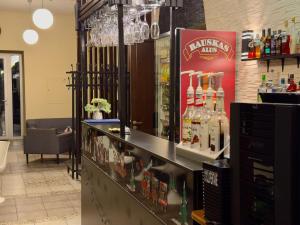 a liquor store with a counter with bottles of alcohol at GRAND Restaurant&Hotel in Daugavpils +19 photos