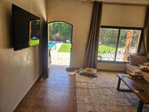 a living room with a couch and a tv at Villa Ama in Marrakesh