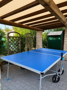 a blue ping pong table sitting on a patio at Aparthotel Costa Paradiso in Lido Adriano