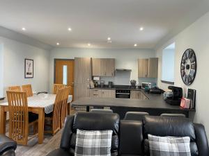 a kitchen and living room with a table and chairs at 19a Francis Street in Stornoway