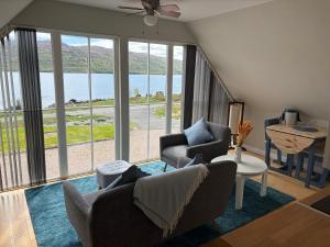 a living room with a view of the water at Rockpool Apartment in Acharacle