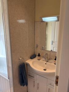 a bathroom with a sink and a mirror at Rockpool Apartment in Acharacle
