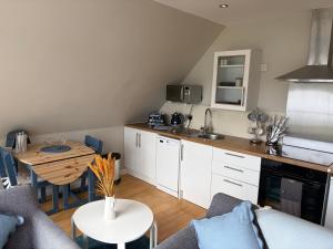 a kitchen and a living room with a table at Rockpool Apartment in Acharacle +7 photos