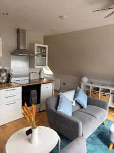 a living room with a couch and a table at Rockpool Apartment in Acharacle