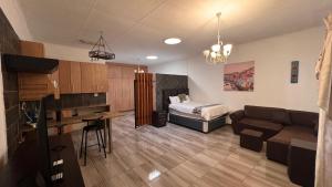 a living room with a couch and a bed in a room at Blue Lantern Bed and Breakfast in Kempton Park