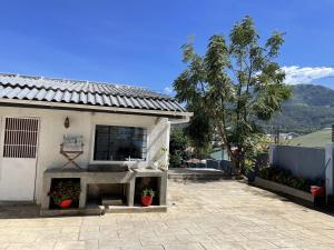 a white house with a fireplace in a yard at 3 bedroom house with a mountain view in Mbeya