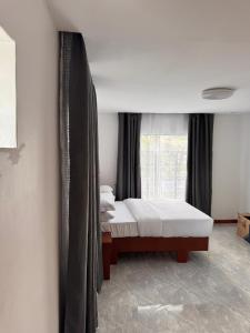 a bedroom with two beds and a window at 3 bedroom house with a mountain view in Mbeya