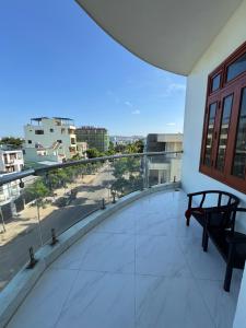 a balcony with a bench and a view of a street at Phương Nhi Motel in Danang