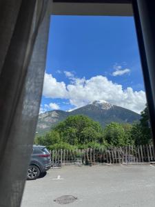 a view of a mountain from a parking lot at Le Secret d'Adèle in Chateauroux-les-Alpes