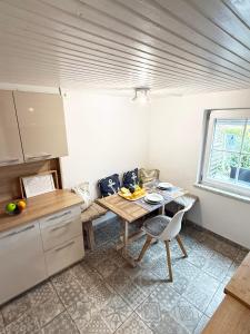 a kitchen with a wooden table and a table and chairs at Fischerhus in Fehmarn