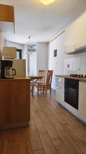 a kitchen with a table and a dining room at Apartment Irene in Pula